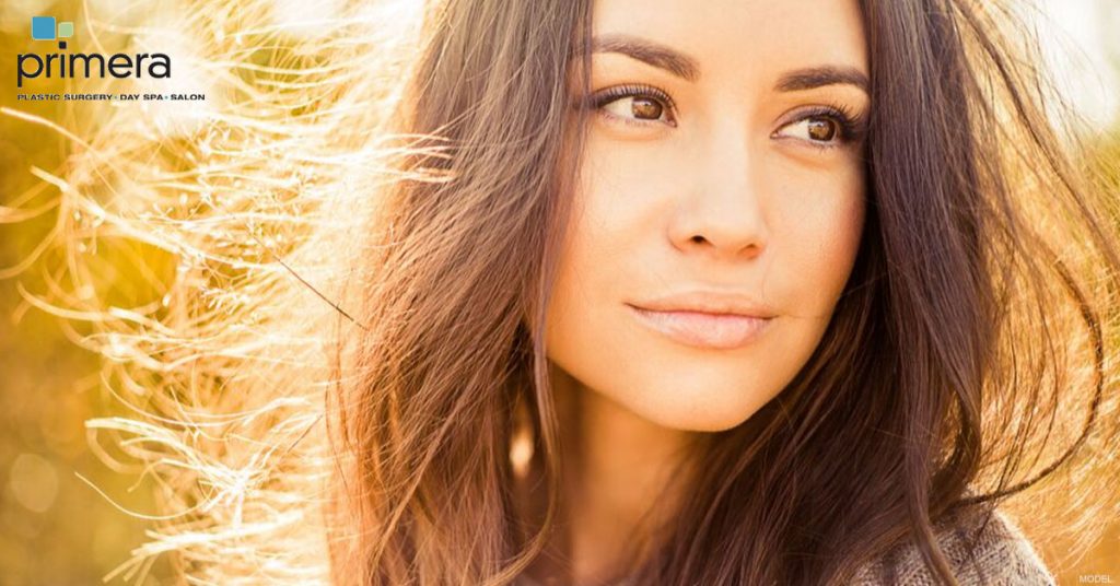 Dark haired woman with attractive nose looking to her right