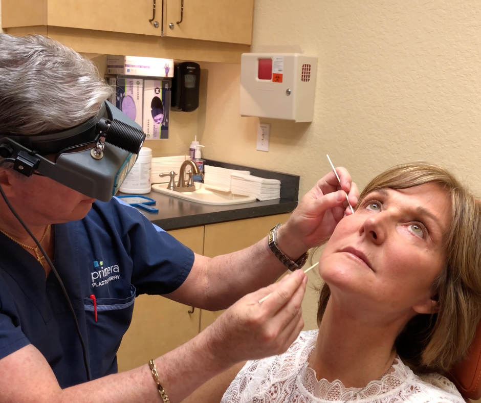 Dr gross in treatment room assessing face of actual patient