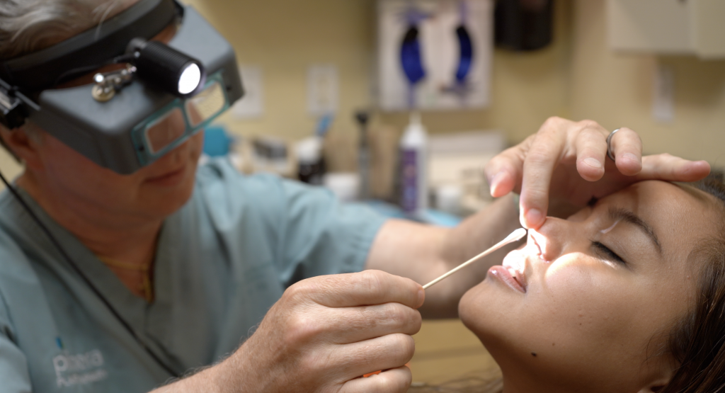 Dr. Gross examining the nose of actual rhinoplasty patient