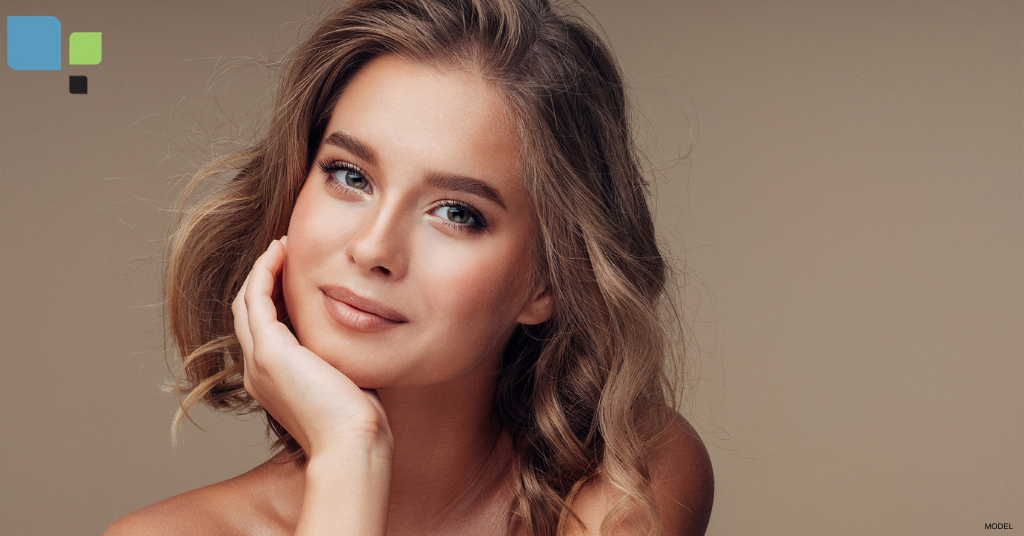 Attractive young woman with chin resting in her hand