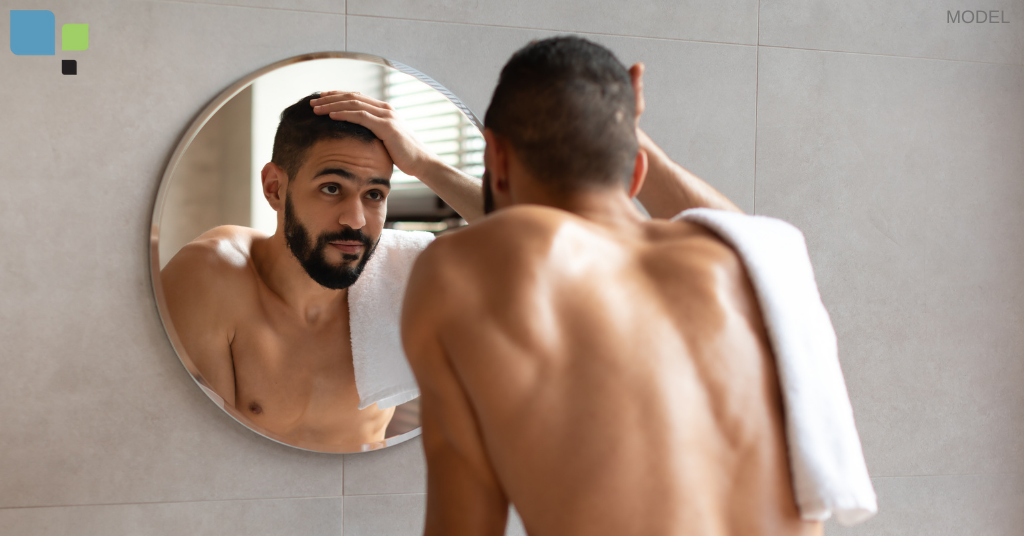 A man inspecting his nose in a bathroom mirror near Orlando, FL