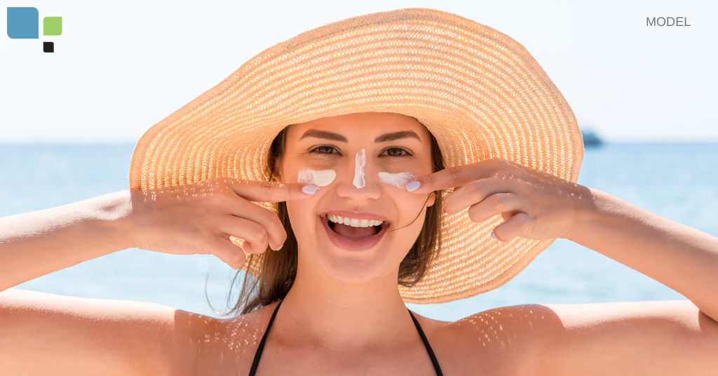 woman in bikini putting sunscreen on her face (model)