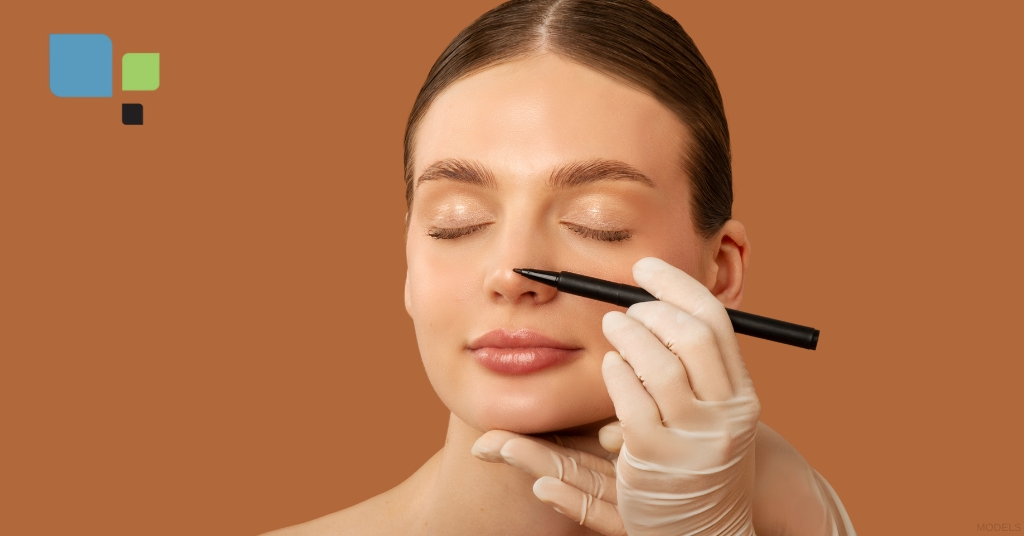 Young woman is getting her nose marked for a rhinoplasty (model)
