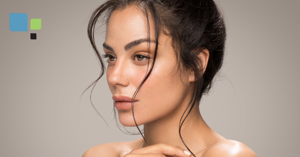 Young woman posing with her hands on her face (model) Primera Plastic Surgery Logo